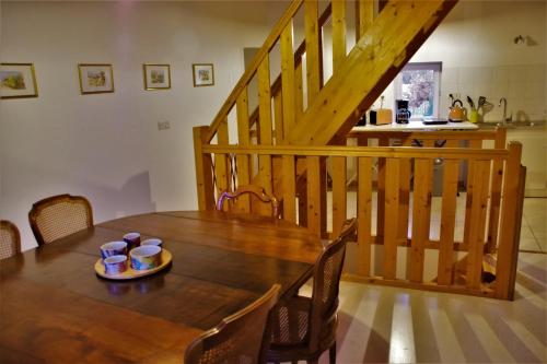 a dining room table with a plate of food on it at Le vieux pont in Saint-Julien