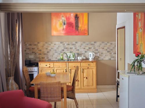 a kitchen with a table and a dining room at Pelican Residence in Fajara