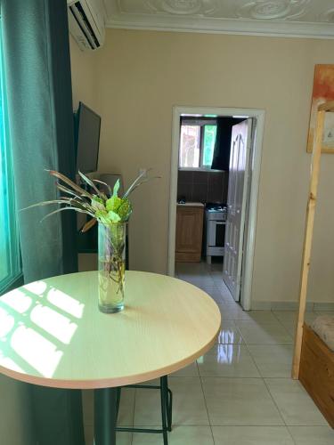 a vase of flowers sitting on top of a table at Pelican Residence in Fajara