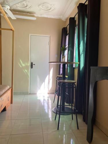 a room with two chairs and a table and a door at Pelican Residence in Fajara