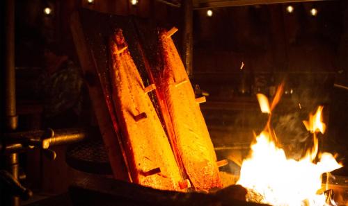 a fire in a forge with flames at Finlandia Hotel Airport Oulu in Kempele