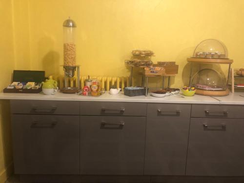 a kitchen with a counter with many items on it at Hotel Christina in Châteauroux