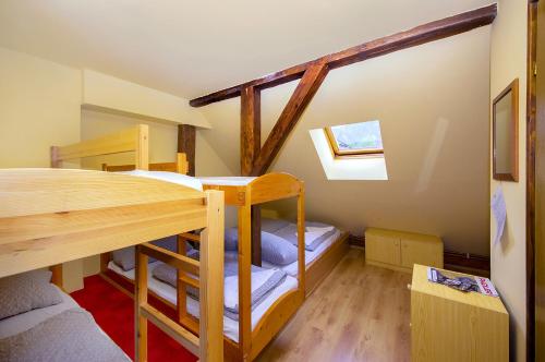 a bunk bed room with two bunk beds at Penzion Black Sheeps Adventures in Wildalpen