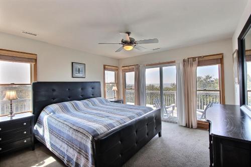 a bedroom with a bed and a balcony at Knock Out #3-MC in Avon