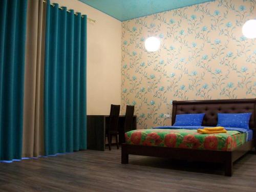 a bedroom with a bed and blue curtains at 2-х комн квартира в новом элитном доме в центральном районе города in Cherkasy