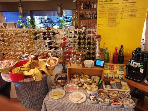 a table with a bunch of food on it at Duinberk B&B hotel en Brasserie in Schoorl