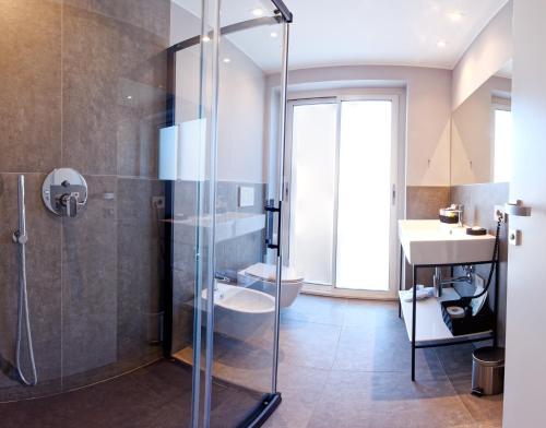 a bathroom with a shower and a toilet and a sink at Albergo Giuan Arma di Taggia in Arma di Taggia