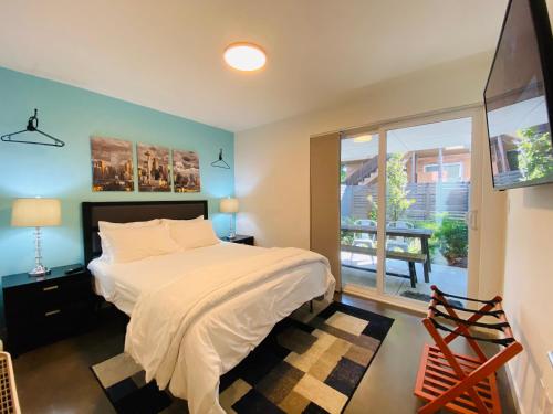 a bedroom with a bed and a large window at Modern Ballard Townhouse - 92 Walkscore & Rooftop! in Seattle