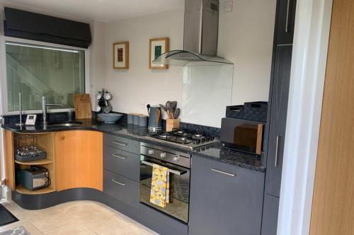 a kitchen with a stove and a counter top at The Annex @ 3 East Town Cottages in West Ashton