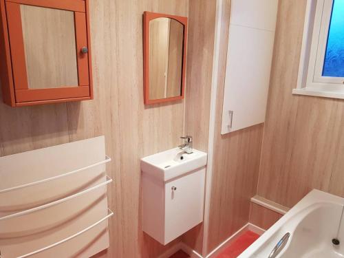 a small bathroom with a sink and a mirror at Apartment - Sleeps 4 - Pet friendly - Balcony in Guisborough