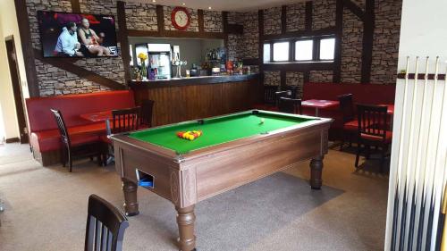a pool table in a room with a bar at Stunning 3-Bed Hot Tub Lodge Northumberland in Felton