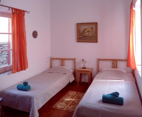 two twin beds in a room with a window at Stunning House - Sleeps 11 Terrace & Sea View in Chrisopigi