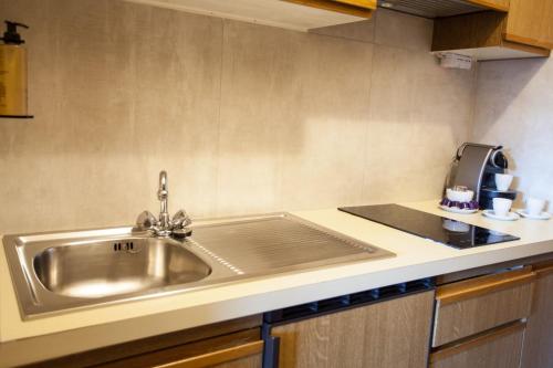 a kitchen with a sink and a counter top at Holiday House Erika in Valdidentro