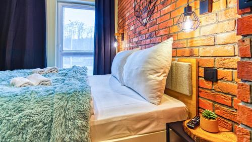Posteľ alebo postele v izbe v ubytovaní Apartament Biały Wilk - 5D Apartamenty