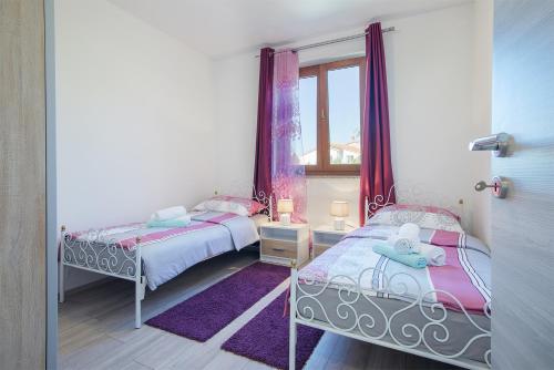 Postel nebo postele na pokoji v ubytování Kaylie Apartment