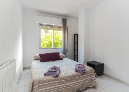 a bedroom with two beds with towels on it at Apartamentos Complutum in Alcalá de Henares