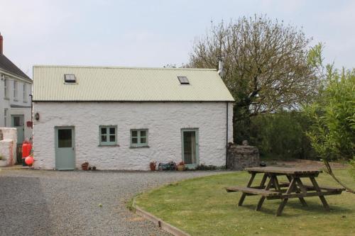 a picnic table in front of a white building at The Dairy @ Mill Haven Place in Haverfordwest