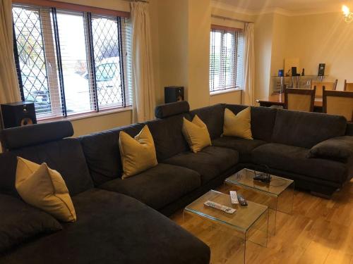 a living room with a couch and a table at Discreet luxury Super house! in Gleann Maghair