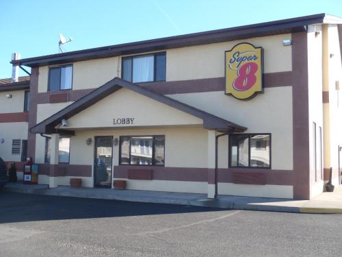 a large building with a sign for a candy store at Super 8 by Wyndham Pendleton in Pendleton
