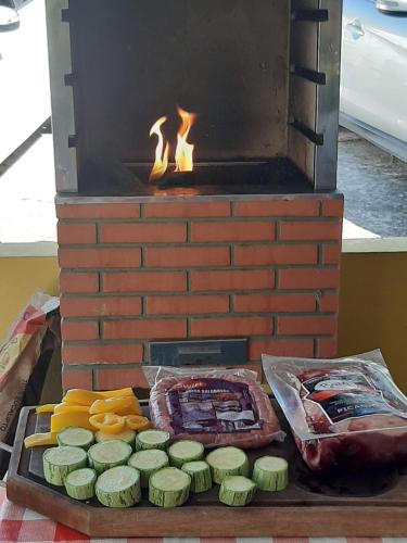 a grill with meat and vegetables on a table at Chalés Tia Nastácia in Monteiro Lobato
