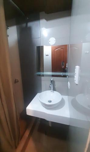 a bathroom with a white sink and a mirror at Kantu Progreso Inn in Cusco