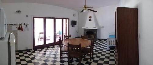 a living room with a table and chairs and a fireplace at Villa Coca -Los Jilgueros- in La Bolsa
