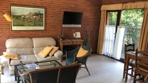 sala de estar con sofá y mesa en DUPLEX Casa 100 m2 CARILO HOUSE Complejo Residencial Sin Serv en Cariló