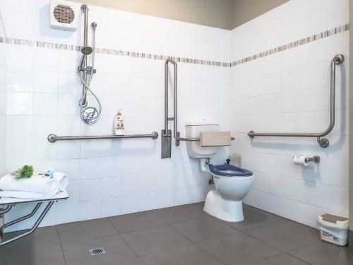 a bathroom with a toilet and a sink at Birches Serviced Apartments in Melbourne