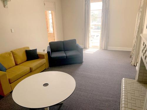 a living room with a couch and a table at Port Macquarie Hotel in Port Macquarie