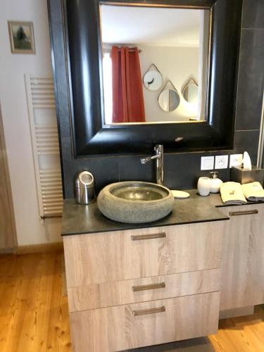 une salle de bain avec un lavabo et un grand miroir dans l'établissement Appartement moderne à Le Grand-Bornand 70 m² avec vue montagne, au Grand-Bornand