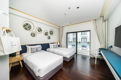 Postel nebo postele na pokoji v ubytování Kram Pattaya