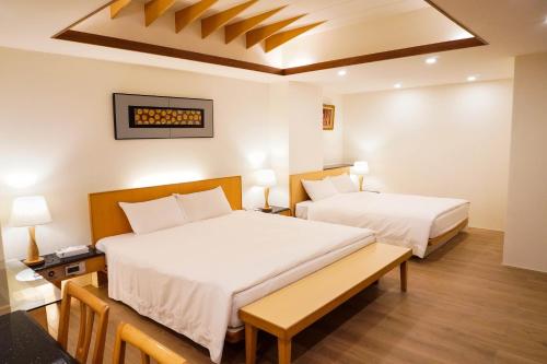 Postel nebo postele na pokoji v ubytování Kao Yuan Hotel - Zhong Zheng