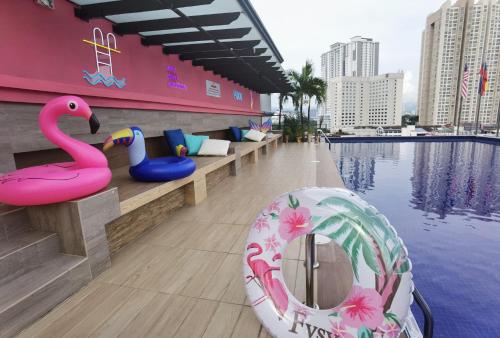 a pool with a pink flamingo and a swan float at Leo Palace New Wing, WTC Kuala Lumpur in Kuala Lumpur