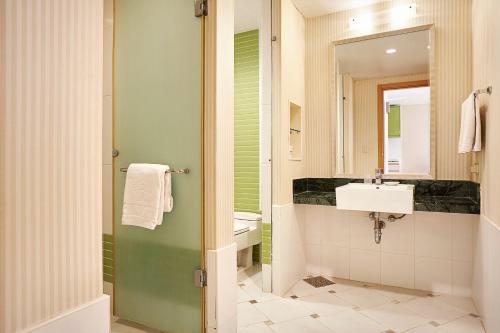 uma casa de banho com um lavatório e um espelho em Oak Valley Resort em Wonju