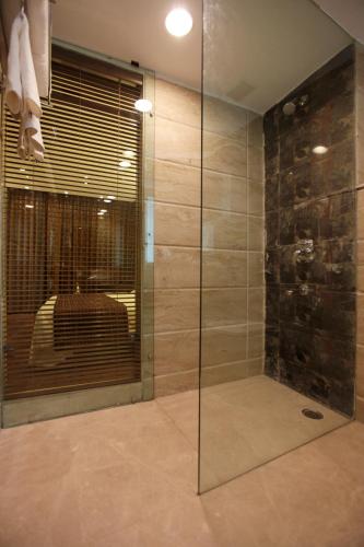 a glass shower in a bathroom with a sink at Hotel Private Affair (A Boutique Hotel) in New Delhi