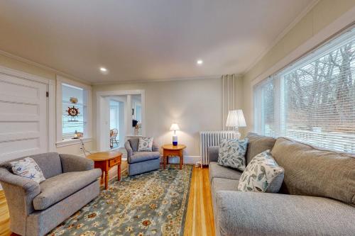 a living room with a couch and chairs and a window at Lisa Jean's Lookout in Boothbay Harbor