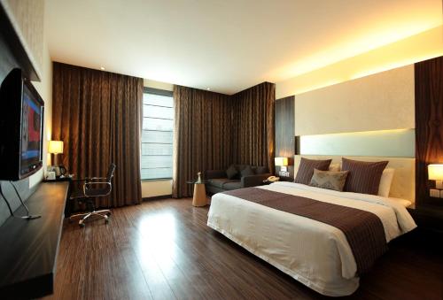 a hotel room with a bed and a television at Hotel Private Affair (A Boutique Hotel) in New Delhi