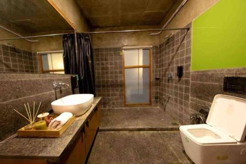 a bathroom with a sink and a toilet at One 90 by the golf@kensville in Nānodra