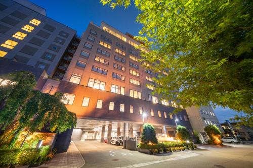 a building with a christmas tree in front of it at Hida Takayama Onsen Hida Hotel Plaza in Takayama