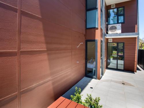a wooden wall of a building with a door at Husky Sands I Pet Friendly I 5 Mins Walk to Beach in Huskisson