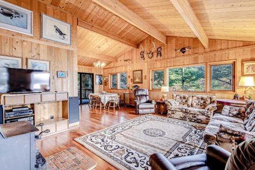 a living room with wood paneled walls and a television at Sound Serenity in Orcas