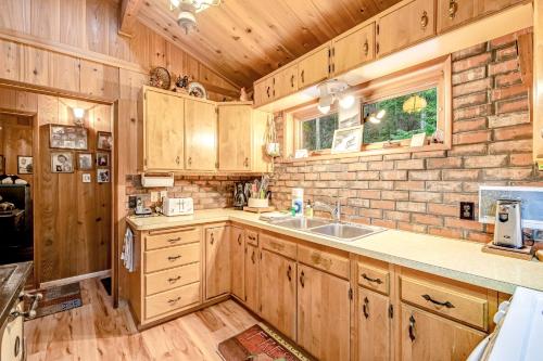 a kitchen with wooden cabinets and a sink at Sound Serenity in Orcas