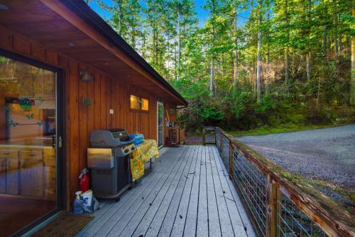 a porch of a cabin with a grill on it at Sound Serenity in Orcas