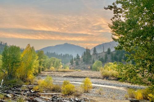 a river in the middle of a field with trees at Sun Valley Alpenglow in Ketchum