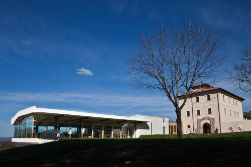 a building with a tree in front of it at Cincinnato Wine Resort in Cori