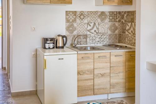 a kitchen with a sink and a counter top at Tommy's Rooms in Haraki
