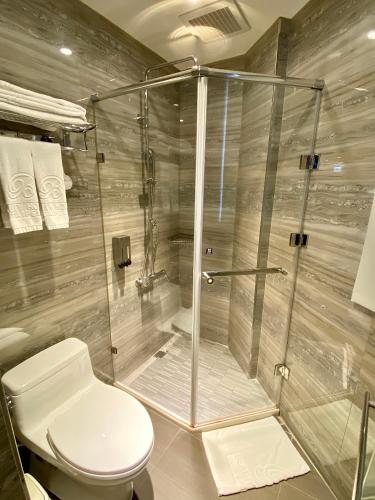 a bathroom with a shower and a toilet at Beauty Hotels Taipei - B7 Journey in Taipei