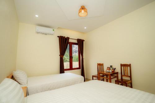 Ένα ή περισσότερα κρεβάτια σε δωμάτιο στο Trang An Freedom Hood