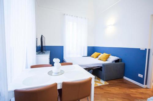 a room with a bed and a table and chairs at Toffee Gioberti - Seven Suites Sanremo in Sanremo