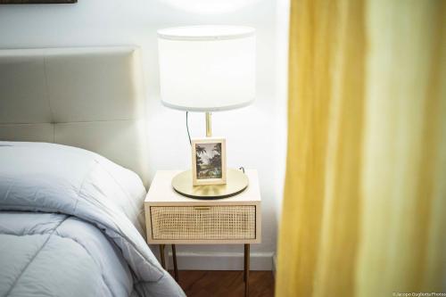 a lamp on a night stand next to a bed at Toffee Gioberti - Seven Suites Sanremo in Sanremo